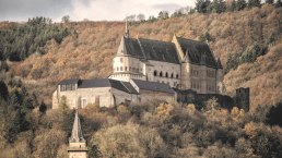 Le château de Vianden trône majestueusement sur une colline, entouré d'arbres aux couleurs de l'automne et d'un ciel nuageux., © Jengel Le château de Vianden trône majestueusement sur une colline, entouré d'arbres aux couleurs de l'automne et d'un ciel nuageux., © Jengel