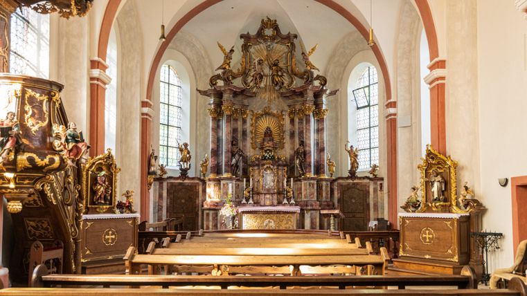 Interior view of the Schankweiler Klause with altar and benches.