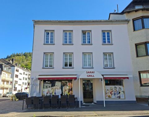 A restaurant called "Saray Grill" with an inviting exterior facade.
In front of the building, there are tables and chairs for guests to sit outside.