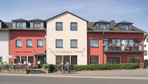 An inviting hotel restaurant with a colorful façade. The outdoor terrace invites you to linger.
