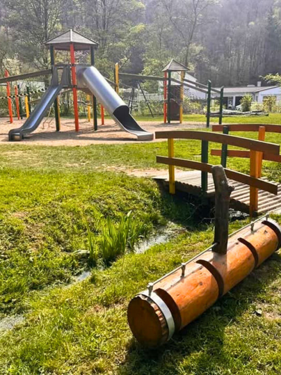 Children's playground in the spa park with stream